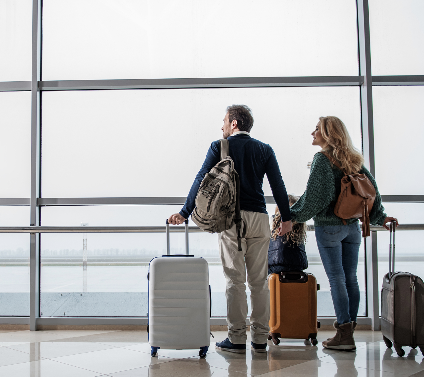 man and woman with luggage in airport