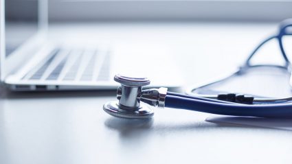 Keyboard and stethoscope on desk