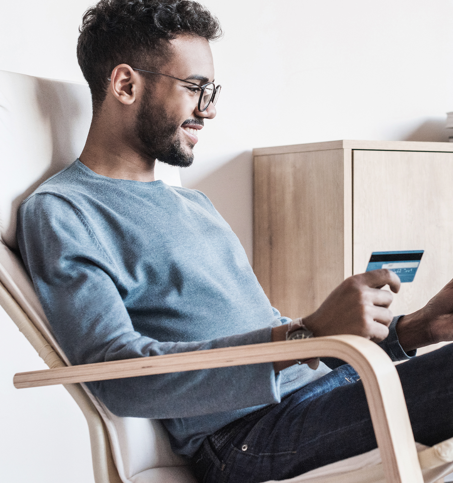 Man sitting holding credit card